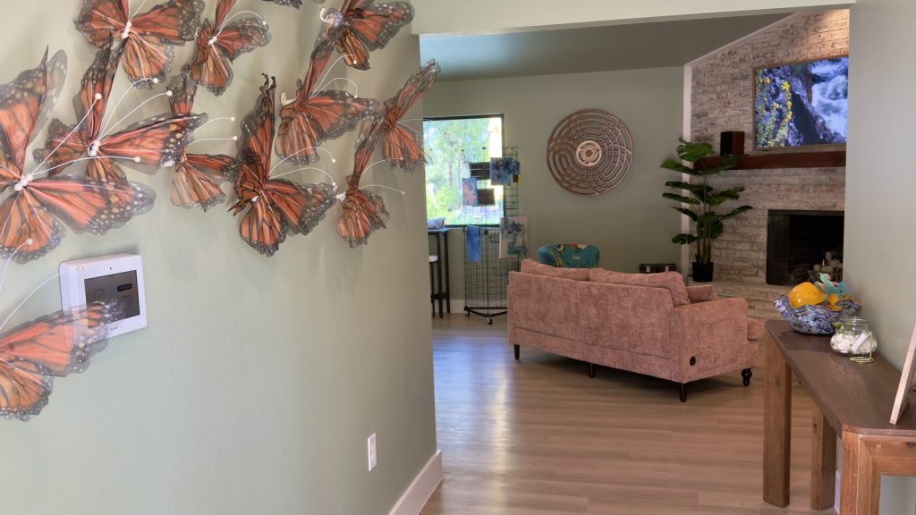 Butterfly wall art at the Adoration entrance, looking into the lounge