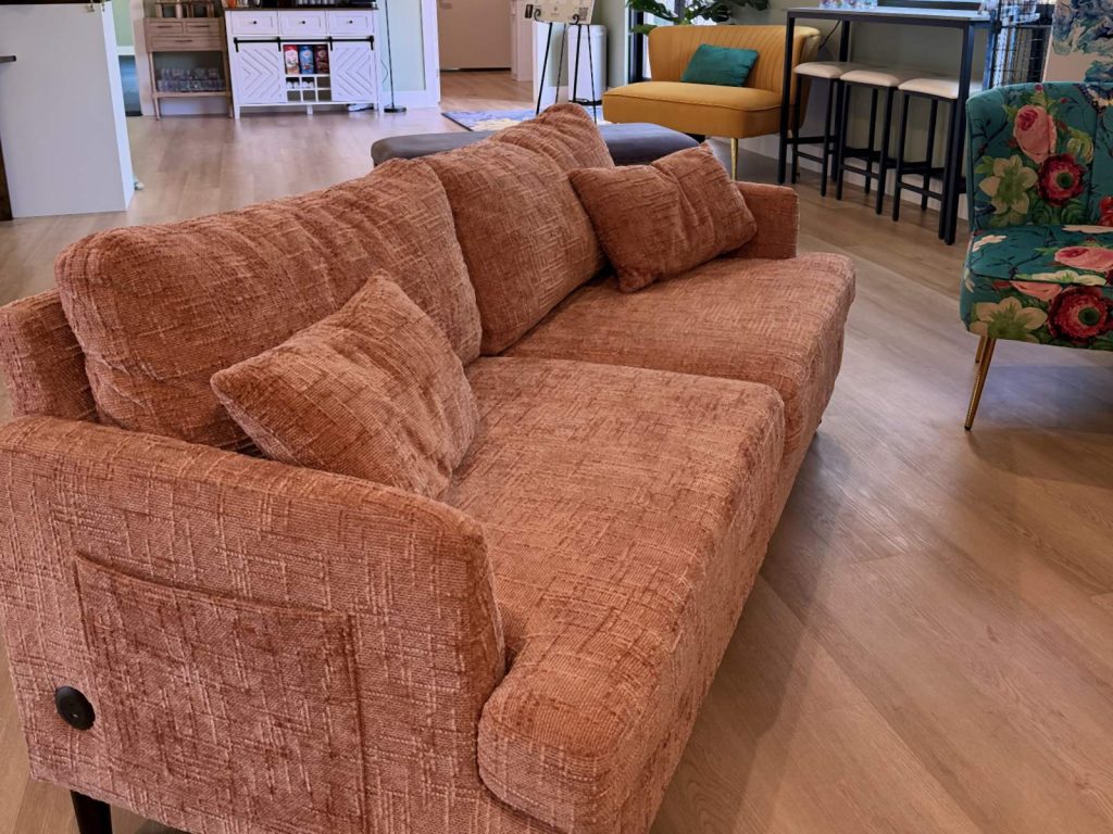 Adoration lounge with a coral sofa and coffee bar seating