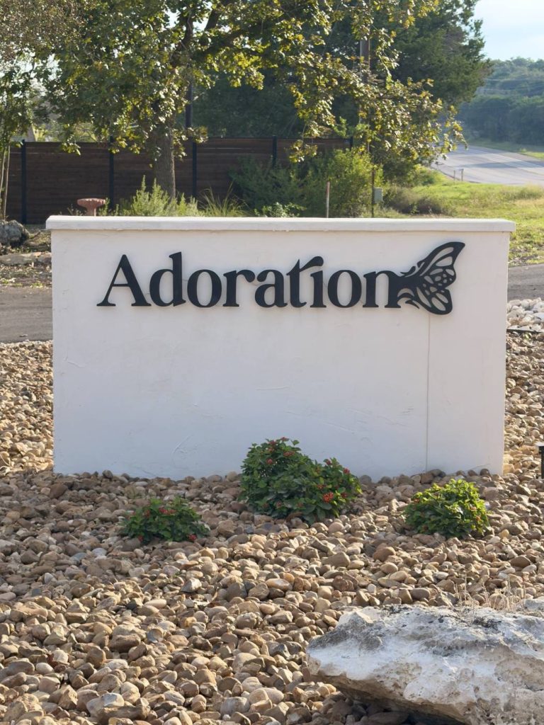 Adoration monument sign with butterfly logo at the office entrance