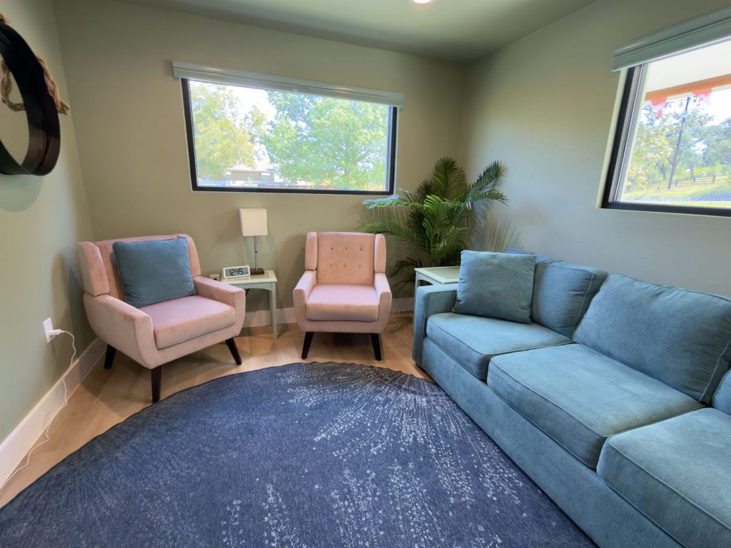 Quiet therapy room at Adoration with a teal sofa