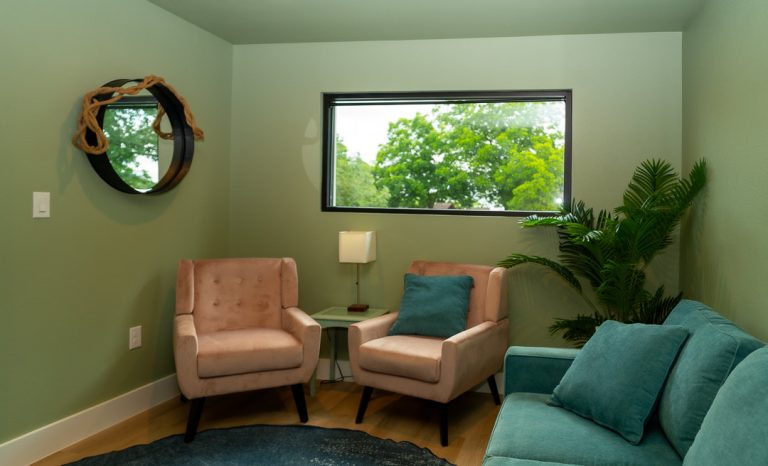Calm Adoration therapy room with sofa and armchairs